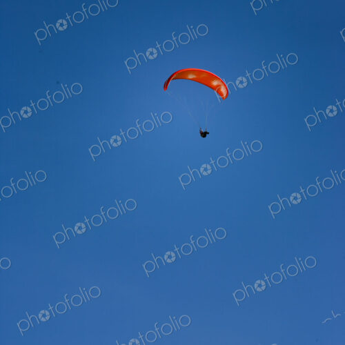 Paraglider above Yakima Canyon with a colourful canopy floating in a blue sky. Paraglider above Yakima Canyon with a colourful canopy floating in a blue sky.