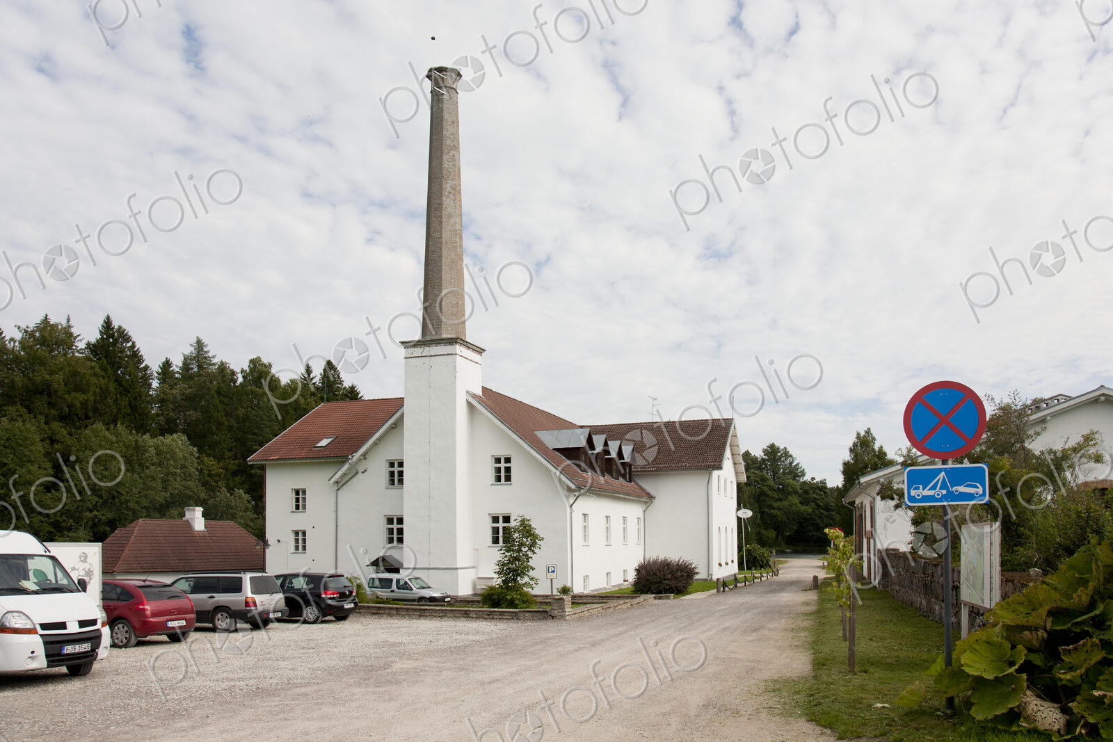 Parking Lot of Building With a Tall Smokestack