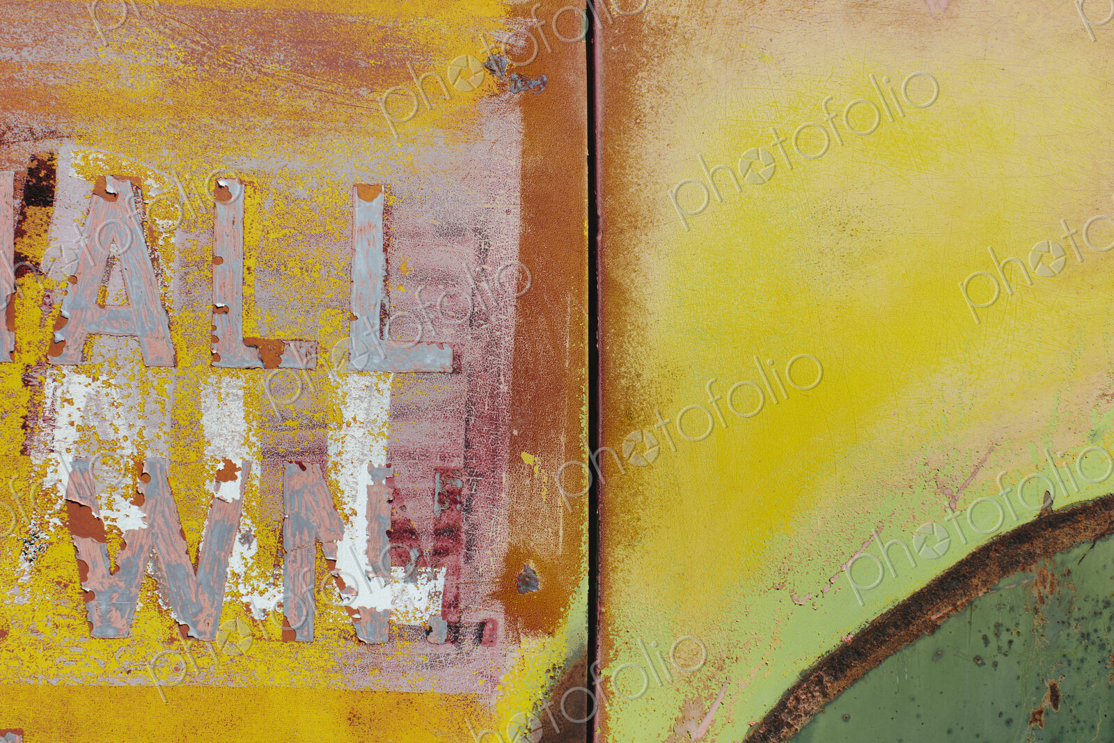 Peeling lettering and paint on side of old, abandoned truck
