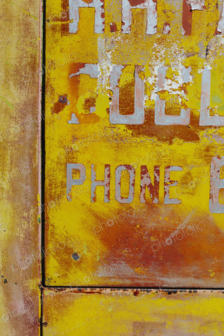 Peeling lettering and paint on side of old, abandoned truck