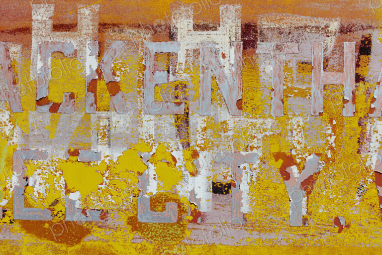Peeling lettering and paint on side of old, abandoned truck