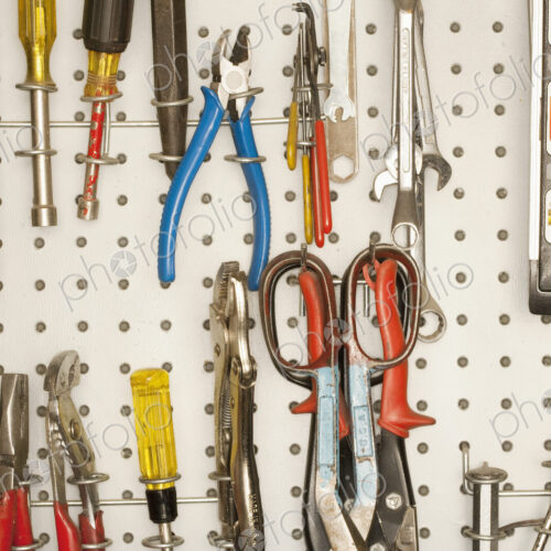 Peg board with tools arranged. Peg board with tools arranged.