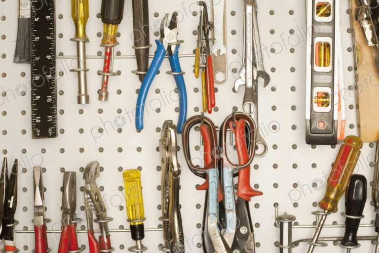 Peg board with tools arranged.