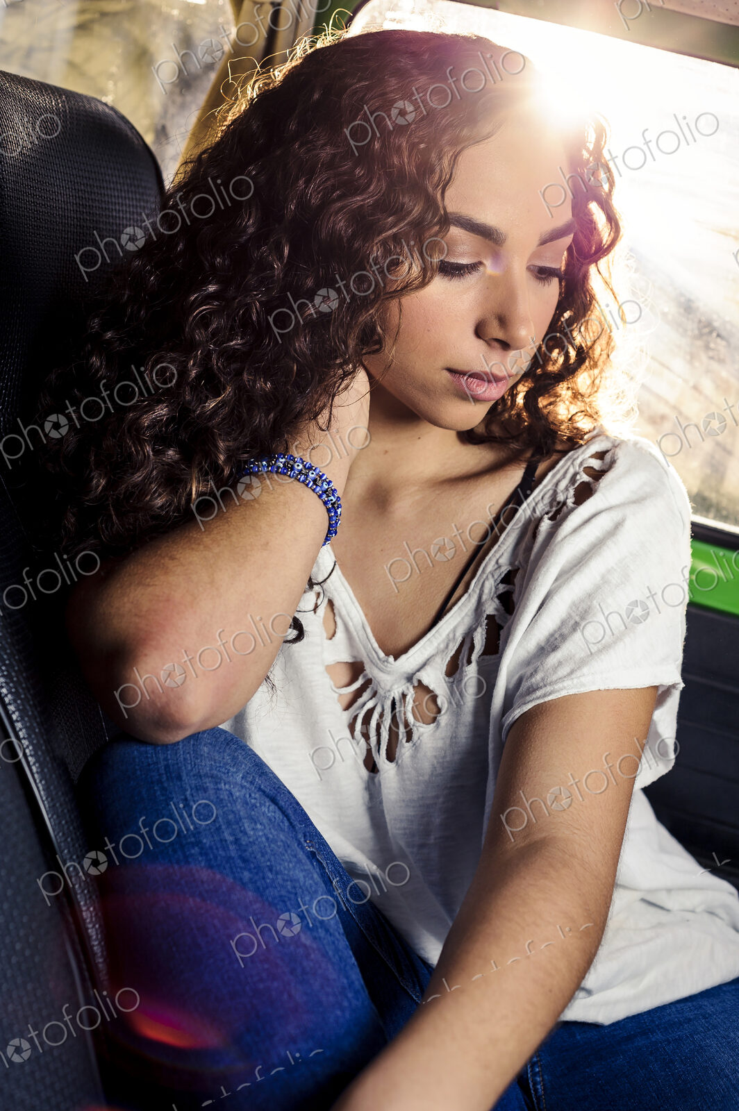 Pensive mixed race woman sitting in car
