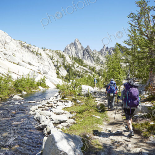 People hiking near remote river People hiking near remote river