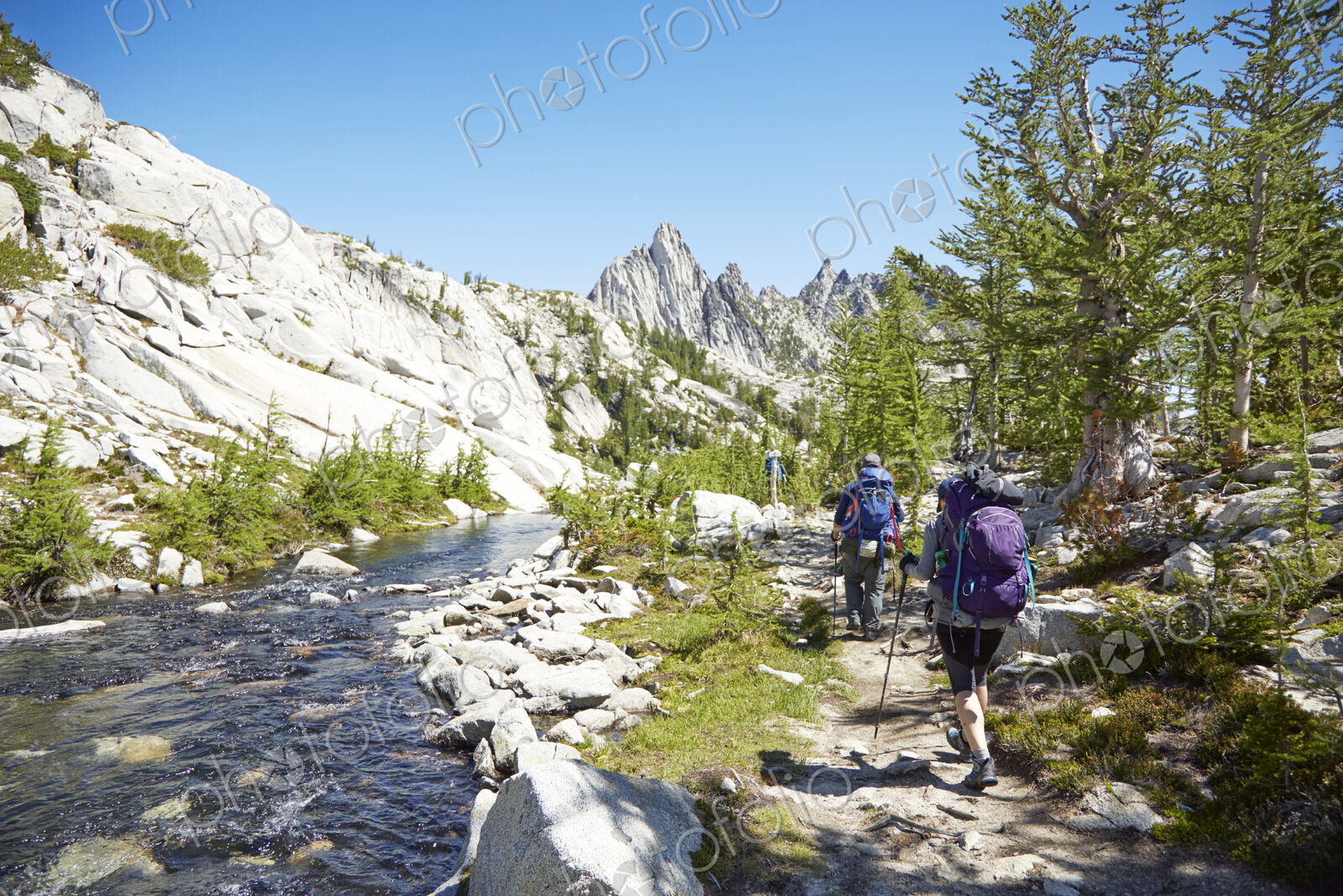 People hiking near remote river