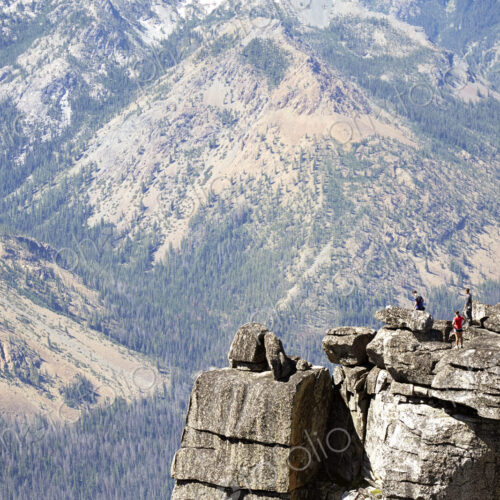 People hiking on rocky hilltop People hiking on rocky hilltop