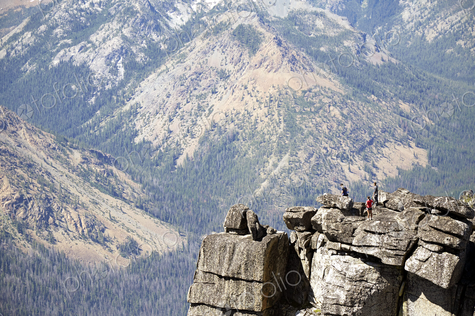 People hiking on rocky hilltop