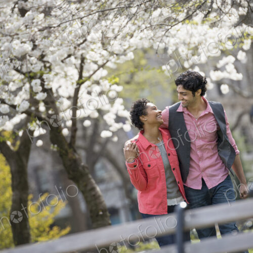 People outdoors in the city in spring time. New York City park. A couple, man and… People outdoors in the city in spring time. New York City park. A couple, man and…