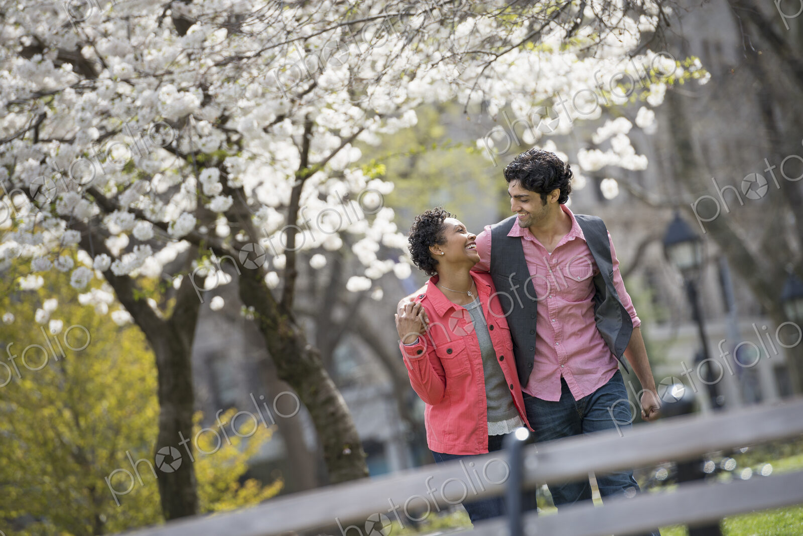 People outdoors in the city in spring time. New York City park. A couple, man and…