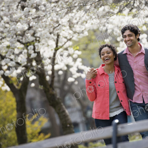 People outdoors in the city in spring time. New York City park. A man and woman side… People outdoors in the city in spring time. New York City park. A man and woman side…