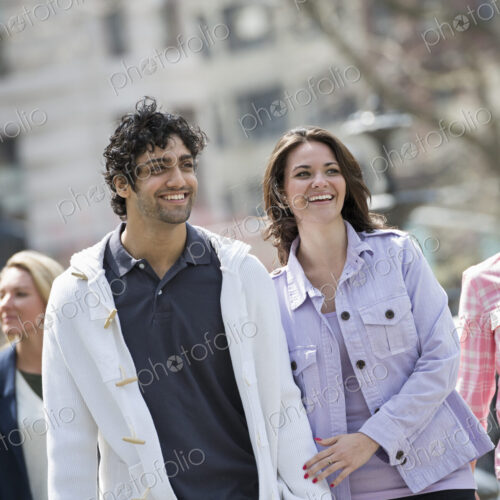 People outdoors in the city in spring time. New York City park. Two people, a couple…