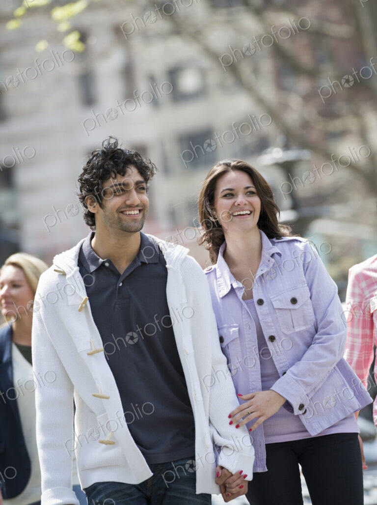 People outdoors in the city in spring time. New York City park. Two people, a couple…
