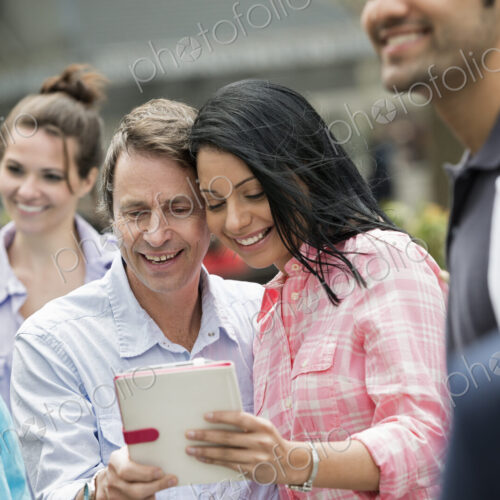 People outdoors in the city in spring time. New York City. A group of men and women, a… People outdoors in the city in spring time. New York City. A group of men and women, a…