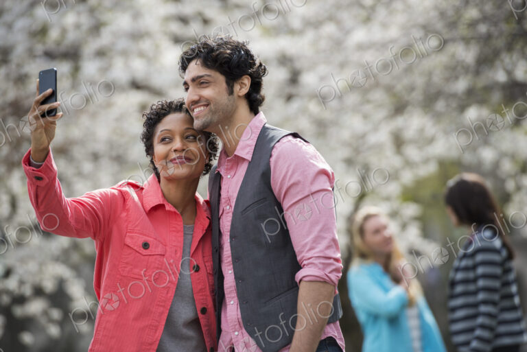 People outdoors in the city, woman taking selfie