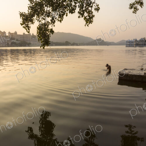 People swimming in a lake in early morning. People swimming in a lake in early morning.