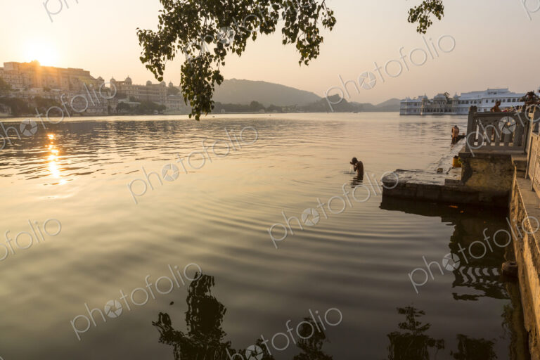 People swimming in a lake in early morning.
