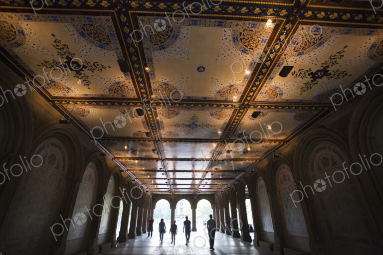 People walking through Bethesda Terrace in Central Park, Manhattan.