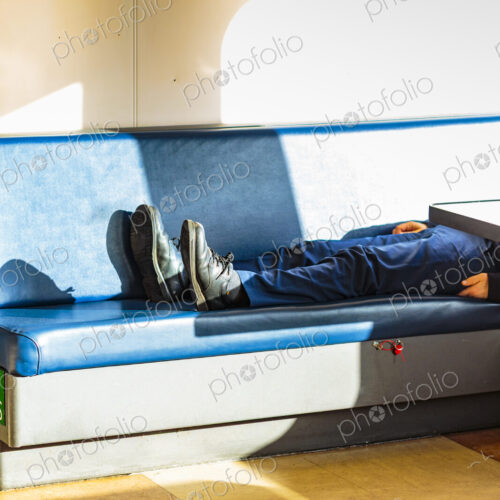 Person asleep on a bench, Seattle ferry Person asleep on a bench, Seattle ferry
