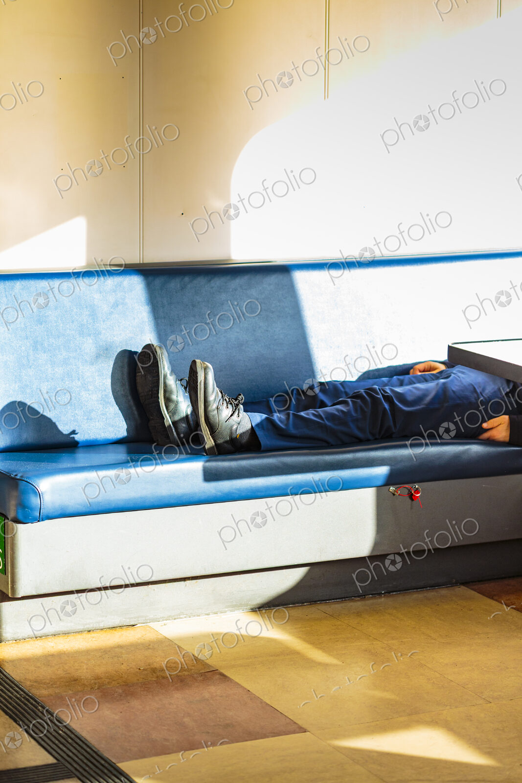 Person asleep on a bench, Seattle ferry