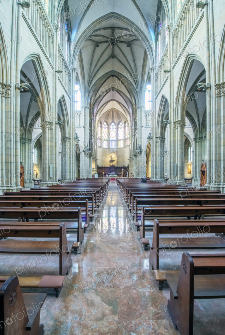 Pews and arches in ornate church