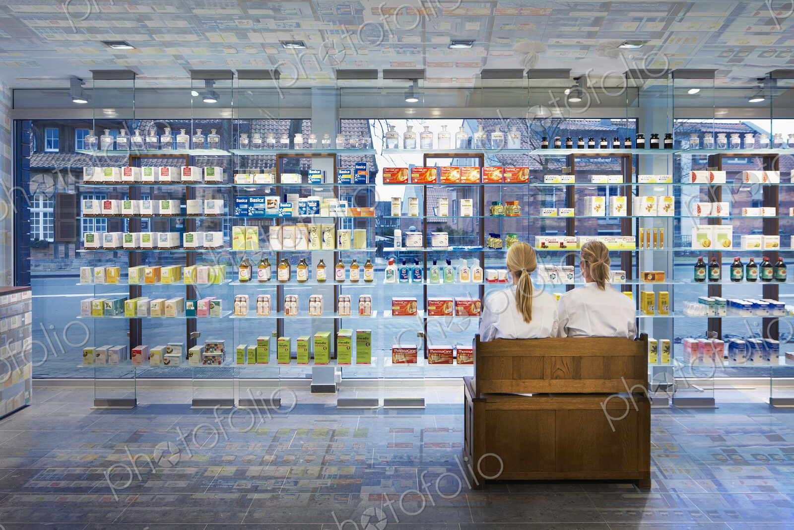 Pharmacists sitting in modern pharmacy