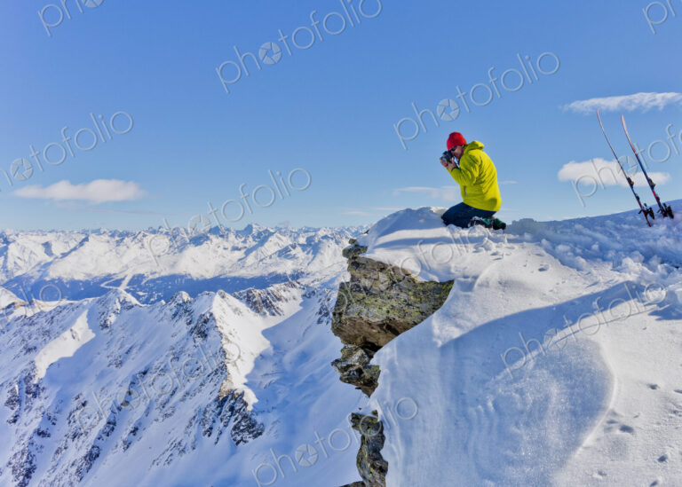 Photographer photographing from snowy mountaintop