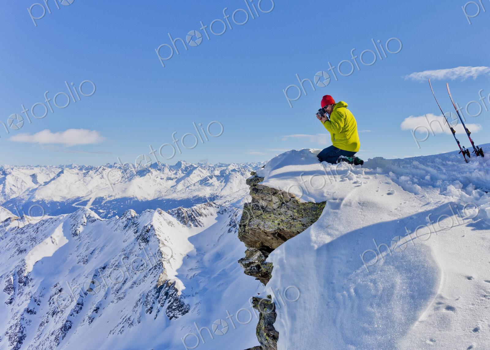 Photographer photographing from snowy mountaintop