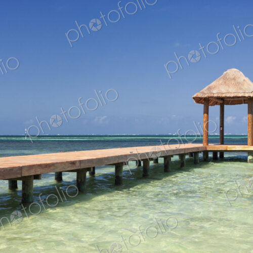 Pier over turquoise blue water on the beach Pier over turquoise blue water on the beach
