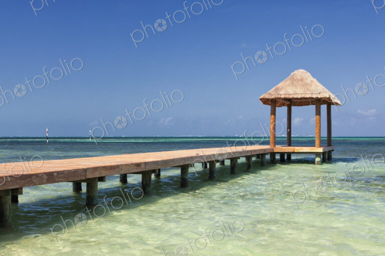 Pier over turquoise blue water on the beach