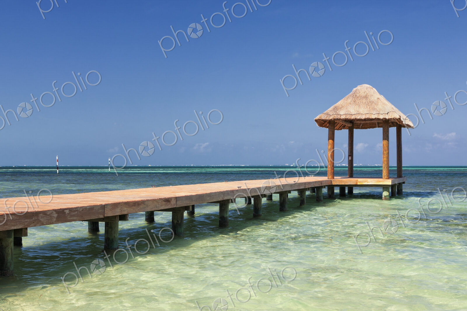Pier over turquoise blue water on the beach