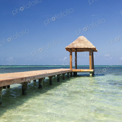Pier over turquoise blue water on the beach Pier over turquoise blue water on the beach