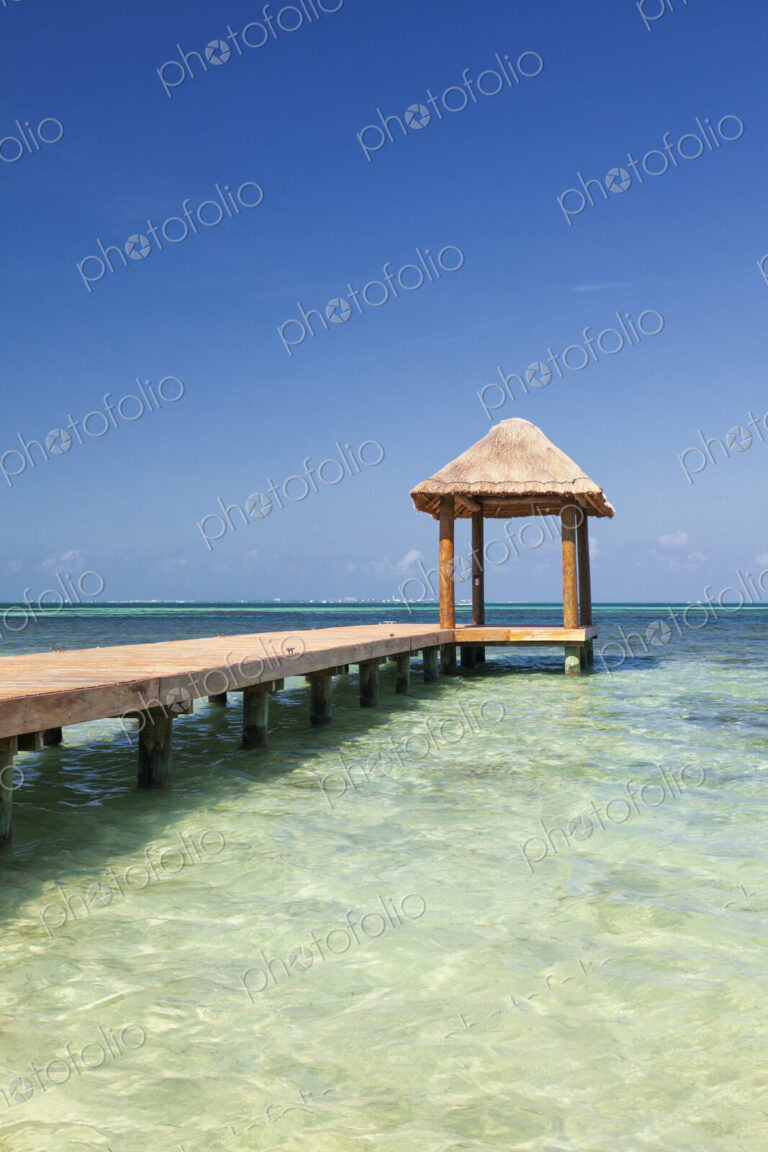 Pier over turquoise blue water on the beach