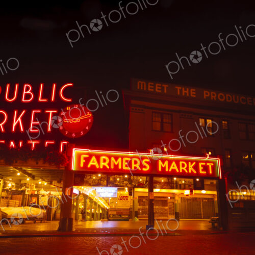 Pike Place Market, Seattle at night, neon signs and empty stalls at the Farmer's market. Pike Place Market, Seattle at night, neon signs and empty stalls at the Farmer's market.