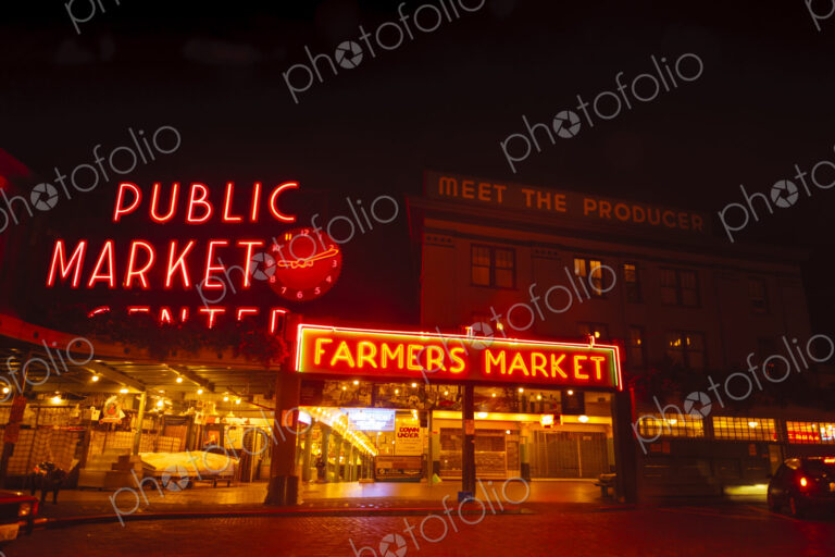 Pike Place Market, Seattle at night, neon signs and empty stalls at the Farmer's market.
