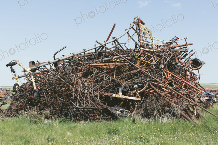 Pile of discarded farming equipment in rural landfill, near Kildeer, Saskatchewan, Canada.