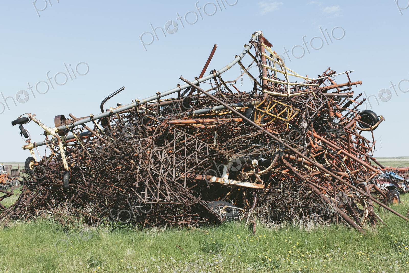 Pile of discarded farming equipment in rural landfill, near Kildeer, Saskatchewan, Canada.
