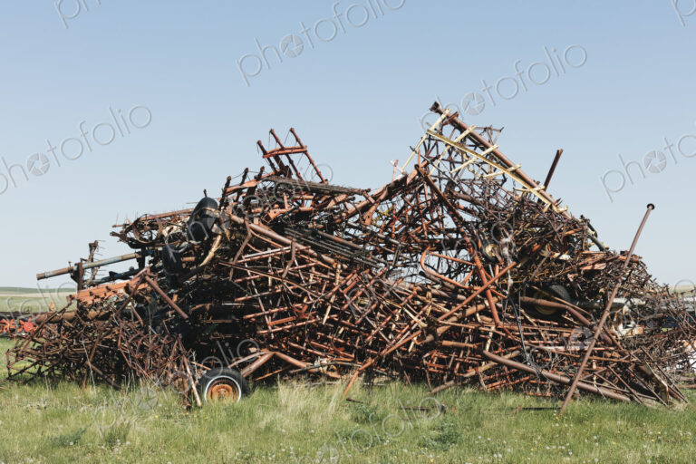 Pile of discarded farming equipment in rural landfill, near Kildeer, Saskatchewan, Canada.