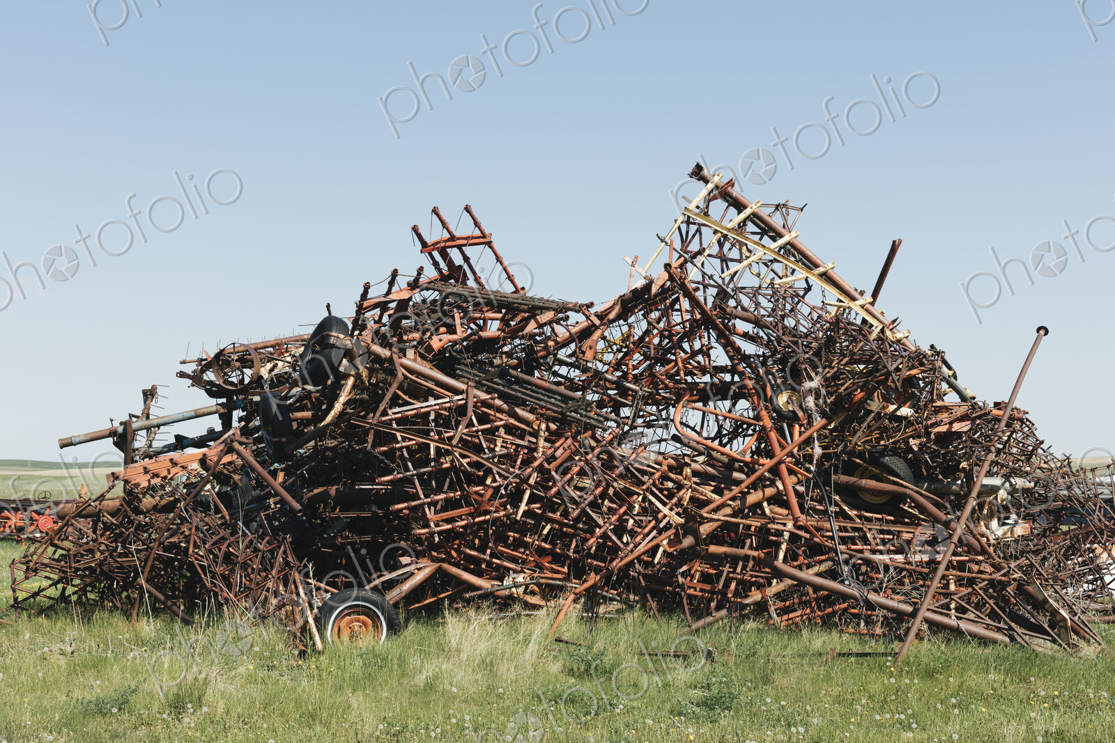 Pile of discarded farming equipment in rural landfill, near Kildeer, Saskatchewan, Canada.