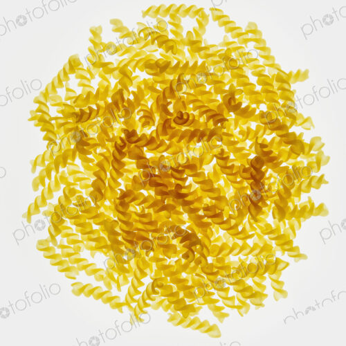 Pile of organic gluten free fusilli pasta spirals, white background Pile of organic gluten free fusilli pasta spirals, white background
