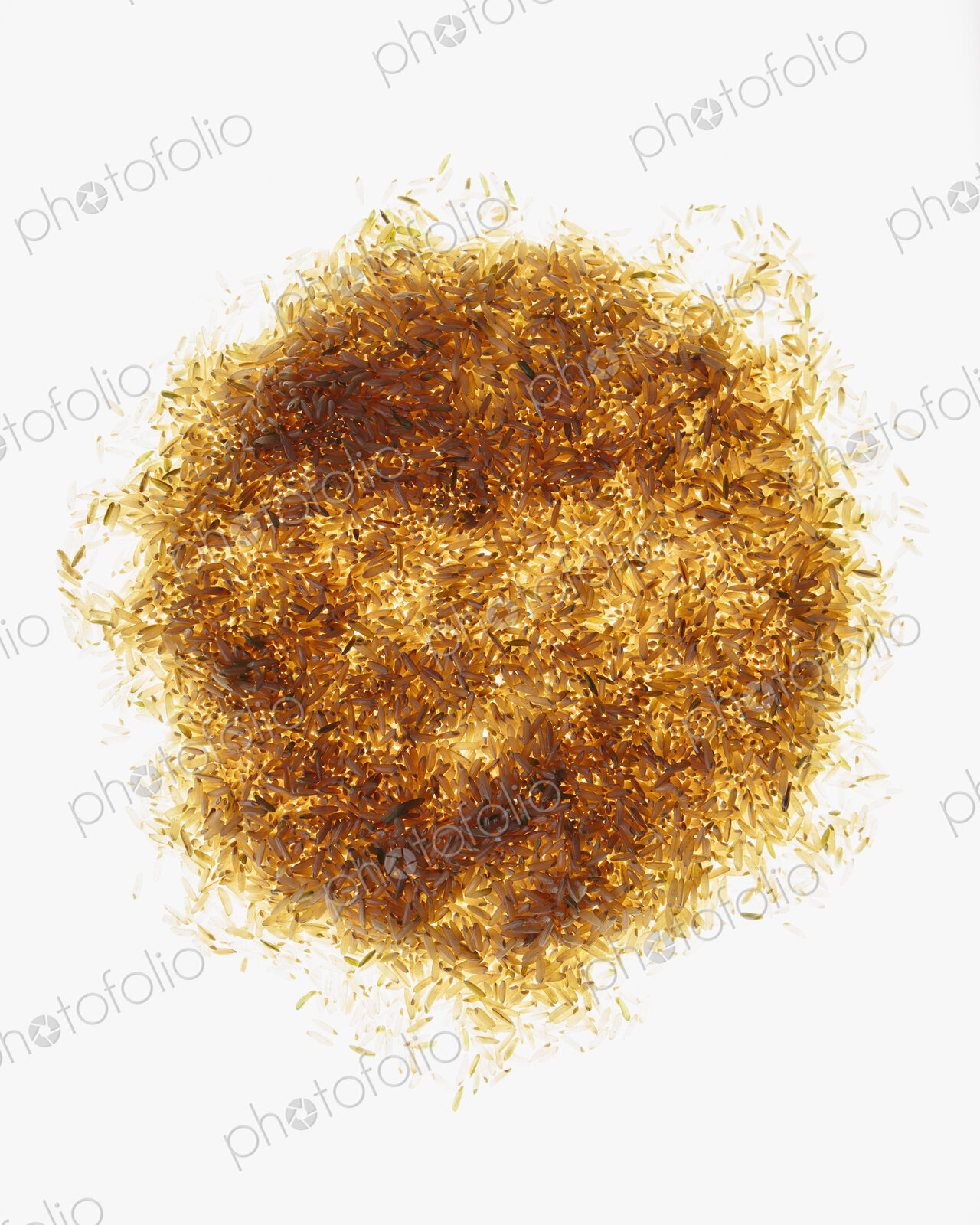 Pile of organic long grain brown rice, white background