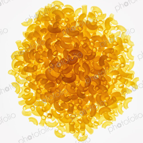 Pile of organic quinoa macaroni pasta elbows, white background (pasta is gluten free) Pile of organic quinoa macaroni pasta elbows, white background (pasta is gluten free)