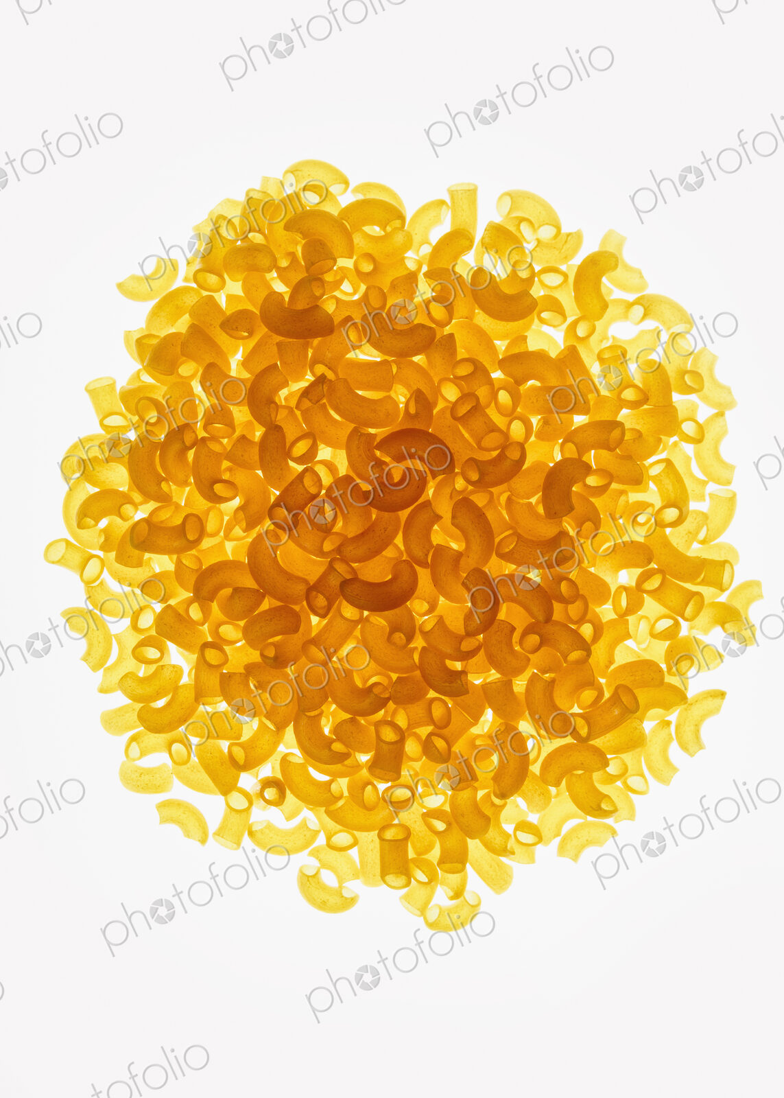 Pile of organic quinoa macaroni pasta elbows, white background (pasta is gluten free)