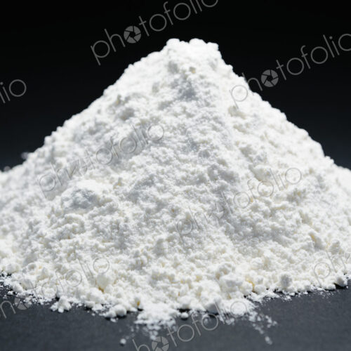 Pile of organic unbleached white flour, black backdrop Pile of organic unbleached white flour, black backdrop