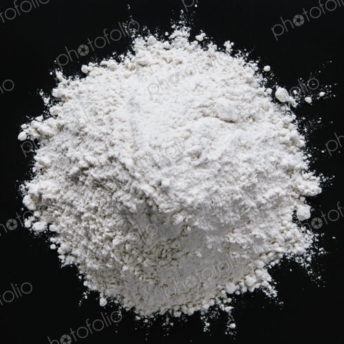 Pile of organic unbleached white flour, black backdrop Pile of organic unbleached white flour, black backdrop