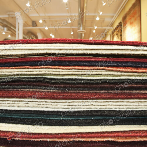 Pile of rugs in a store.