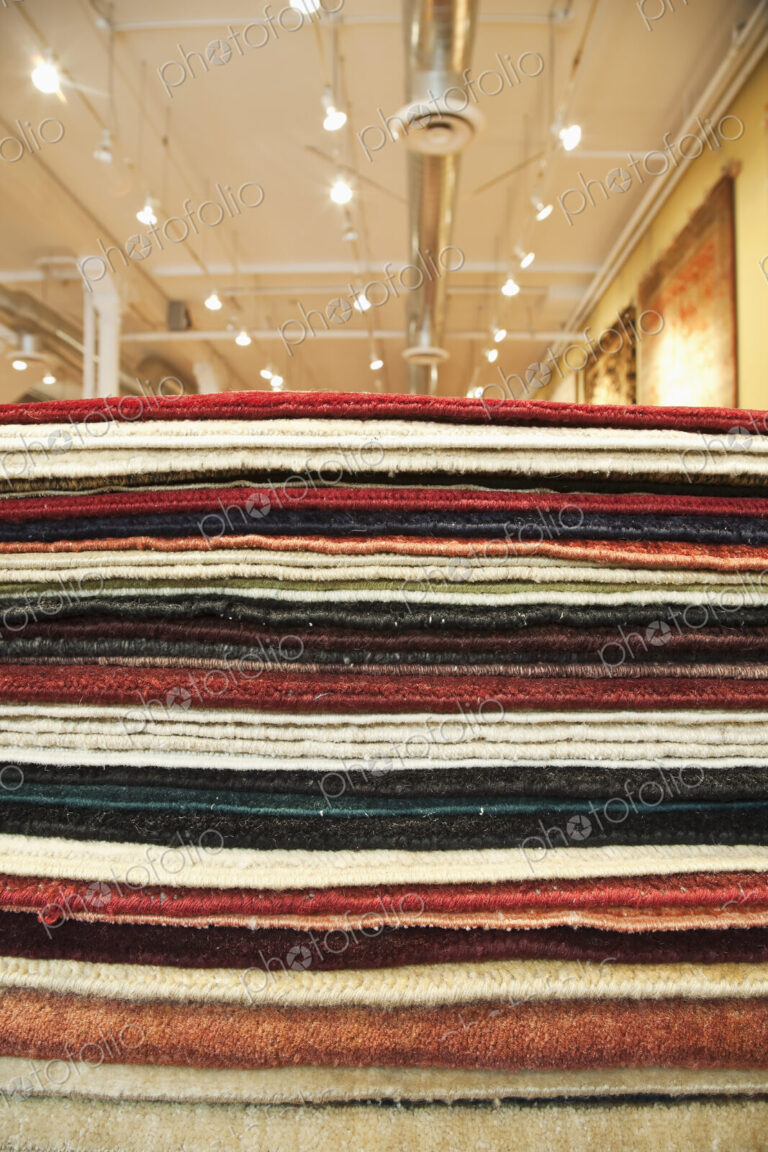 Pile of rugs in a store.