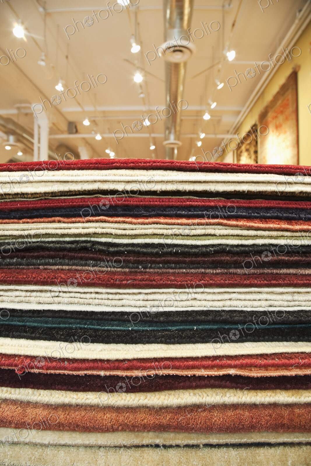 Pile of rugs in a store.