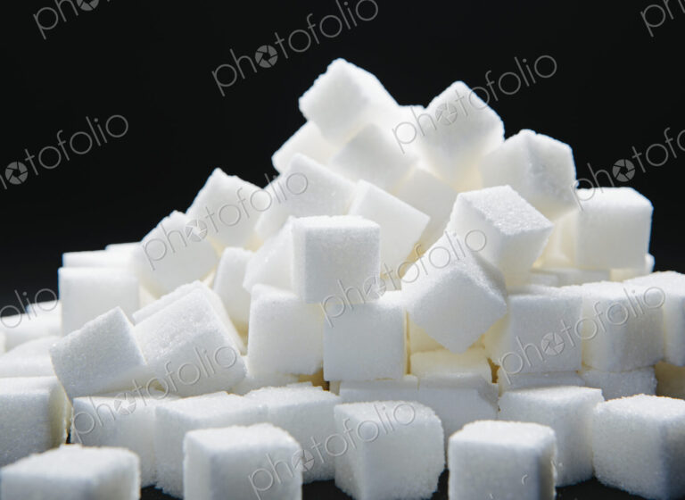 Pile of sugar cubes, black backdrop