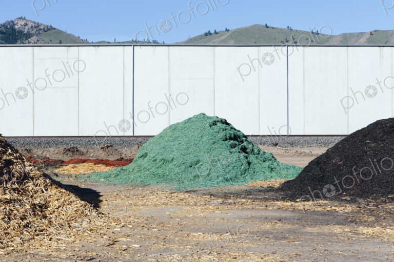 Piles of green bark wood chips used for landscaping, near Quincy